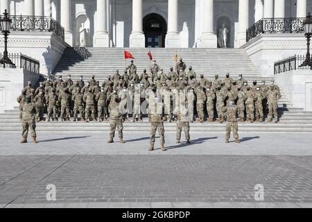 U.S. Army soldiers assigned to the 112th Field Artillery Regiment, New jersey National Guard, take company photos in front of the Capitol steps, Mar. 6, 2021, Washington D.C. The National Guard has been requested to continue supporting federal law enforcement agencies with security, communications, medical evacuation, logistics, and safety support to state, district and federal agencies through mid-March. Stock Photo