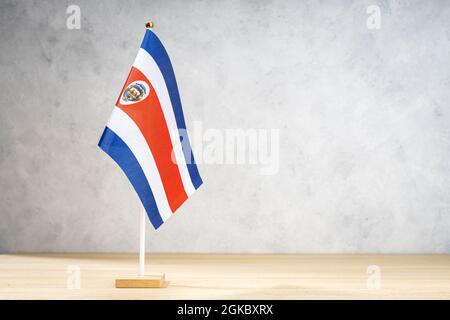 Costa Rica table flag on white textured wall. Copy space for text, designs or drawings Stock Photo