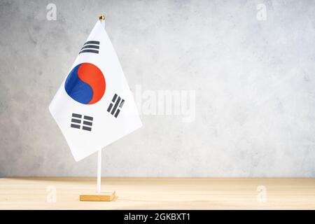 South Korea table flag on white textured wall. Copy space for text, designs or drawings Stock Photo