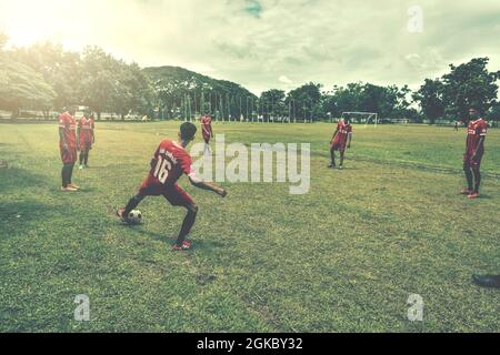 BURIRAM,THAILAND - JUNE 25,2017: UnIdentified of Youth Football Players Kicking on Wet School Football Field after rain To Welcome The World Cup Seaso Stock Photo