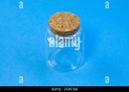 Empty little bottles with cork stopper on blue background front view Stock Photo