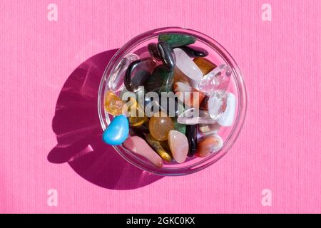 Collection Of Semi-Precious Gemstones on pink textured board background close up Stock Photo