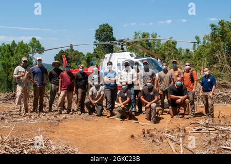 U.S. service members and civilians with the Defense POW/MIA Accounting Agency (DPAA), pose for a photo with Ambassador W. Patrick Murphy, U.S. Ambassador to Cambodia, during a recovery mission in the Ratanakiri Province, Cambodia, March 9, 2021.DPAA's mission is to achieve the fullest possible accounting for missing and unaccounted-for US personnel to their families and our nation. Stock Photo