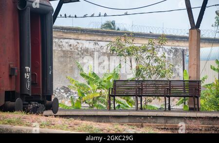 The empty Train station in Galle. No crowd as Covid19 restrictions. Empty bench and an idle train in the photo. Stock Photo