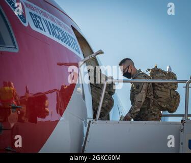 Soldiers from the Connecticut National Guard’s 1-102nd Infantry Regiment board a Boeing 767-300ER at Bradley Air National Guard Base in East Granby, Connecticut, March 10, 2021. The “AirKraft” transported more than 100 deploying Soldiers who will be supporting Operation Enduring Freedom’s Horn of Africa mission. Stock Photo