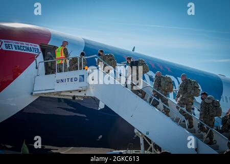 Soldiers from the Connecticut National Guard’s 1-102nd Infantry Regiment board a Boeing 767-300ER at Bradley Air National Guard Base in East Granby, Connecticut, March 10, 2021. The “AirKraft” transported more than 100 deploying Soldiers who will be supporting Operation Enduring Freedom’s Horn of Africa mission. Stock Photo