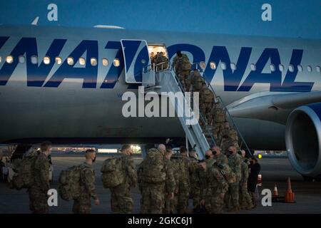 Deploying Soldiers from the Connecticut National Guard’s 1-102nd Infantry Regiment board an Airbus A330-200 at Bradley Air National Guard Base in East Granby, Connecticut, March 10, 2021. Nearly 600 members of the 1-102nd will be supporting Operation Enduring Freedom’s Horn of Africa Mission Stock Photo