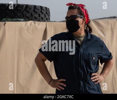 U.S. Air Force Technical Sgt. Luz Soto, 386th Expeditionary Logistics Readiness Squadron fuels facilities noncommissioned officer in charge, celebrates the contributions of women to national defense by dressing as “Rosie the Riveter” at Ali Al Salem Air Base, Kuwait, March 10, 2021. “Rosie” was portrayed as female factory worker who flexed her muscles and encouraged women to join the WWII effort with the declaration, “We Can Do It!” Stock Photo