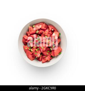 salad of fresh tomatoes and green onions, in a gray cup, a close-up view from above. isolate on a white background. Stock Photo
