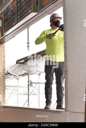 Department of Public Works contractors replace windows at the RIA Hydroelectric Power Plant and Dam at Building 160, March 10. The history of water power on Rock Island Arsenal goes back many years, but the most noticeable trace of it is seen at the hydroelectric dam and power plant located on Sylvan Slough, a backwater of the Mississippi River. The Rock Island Arsenal DPW preserves installation infrastructure and is a large part of garrison operations. Stock Photo