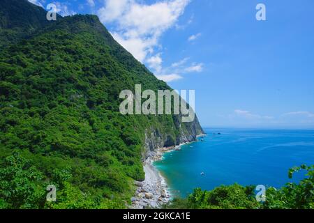 Sea, sky, mountains and sea facing each other, multi-layered blue of the coast. The Qingshui Cliff is the only coastal road in Taroko National Park. H Stock Photo