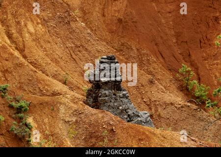 Nature rock among the red soil Stock Photo