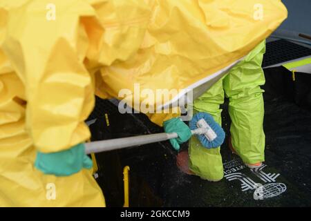 Members from the 51st Civil Engineer Squadron and the 51st Aerospace Medicine Squadron go through a hot wash at Osan Air Base, Republic of Korea, March 11, 2021. The wash was part of a routine training event involving a suspicious package call. Stock Photo