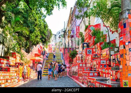 A group of tourists visiting the 'Selaron Steps (Escadaria Selaron) in the Napa district in Rio de Janeiro, Brazil. The art is by Chilean artist Jorge Stock Photo