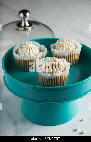 Three mini pumpkin cheesecakes on a teal cake tray. Stock Photo