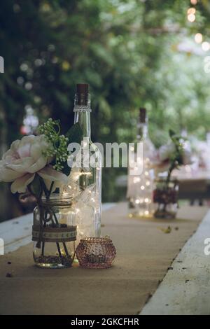wooden tables laid with wedding decorations Stock Photo