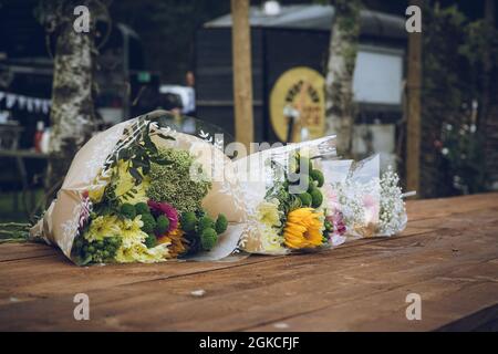 bouquets of flowers laid on a wooden table Stock Photo