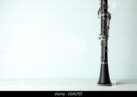 Clarinet on white wooden background, space for text. Stock Photo