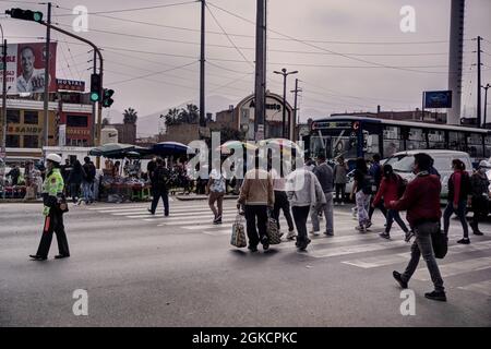 Lima, Peru - July 27, 2021: People using crosswalk in Lima Peru Stock Photo