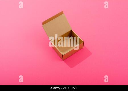 Composition of open empty cardboard gift box on pink background Stock Photo