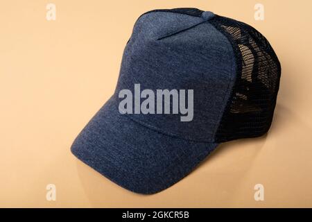 Composition of close up of grey and black baseball cap with mesh back on yellow background Stock Photo
