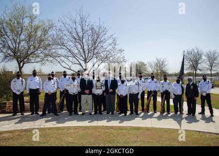 Members of the Fort Sam Houston Memorial Services Detachment along with  Mr. Robert C. (Bob) Winkler and Mr. Graham L. Wright III, Assistant Directors of the U.S. Department of Veterans Affairs National Cemetery Administration Fort Sam Houston National Cemetery pose for a photo at the Fort Sam Houston National Cemetery in San Antonio, Texas, March 15, 2021. A ceremony was held to commemorate the detachment’s 40,000th funeral service. Stock Photo