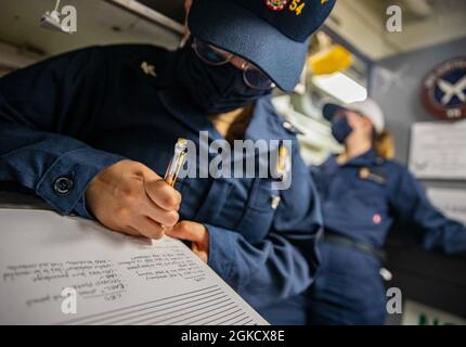 EAST CHINA SEA (March 16, 2021) Culinary Specialist 2nd Class Melissa Juarez-Garcia, takes notes during a medical training scenario aboard the Arleigh Burke-class guided-missile destroyer USS Curtis Wilbur (DDG 54). Curtis Wilbur is assigned to Task Force 71/Destroyer Squadron (DESRON) 15, the Navy’s largest forward DESRON and the U.S. 7th Fleet’s principal surface force Stock Photo