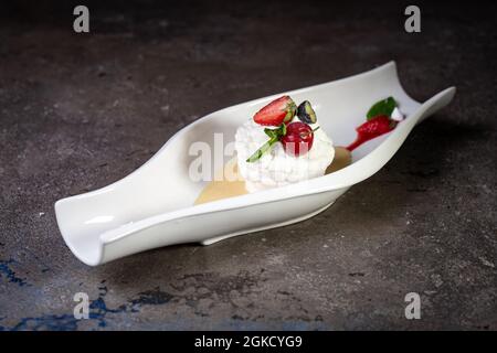 Beautiful Pavlova Cakes With Strawberries on a white plate. Stock Photo