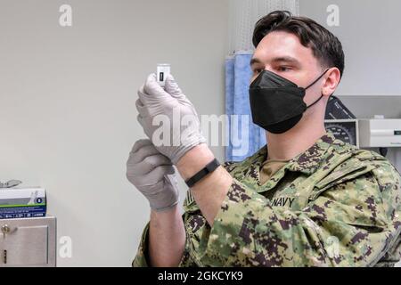 210216-N-ZU848-0019 CHINHAE, Republic of Korea (Mar. 16, 2021) Hospital Corpsman 2nd Class Jordan Stankey fills a syringe with COVID-19 vaccine. Sailors assigned to Navy Branch Health Clinic Chinhae and Soldiers assigned to the 549th Medical Hospital Center, 65th Medical Brigade administered the second dose of the COVID-19 vaccine, on a completely voluntary basis, to Sailors who were identified as front line personnel by their commands. Stock Photo