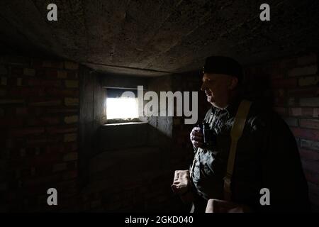 Assistant ranger Rupert Eris dressed in Home Guard uniform at one of two restored WWII pillboxes in Sheringham Park, Norfolk, which are being opened to the public as part of the National Trust's Heritage Open Days. Picture date: Tuesday September 14, 2021. Stock Photo