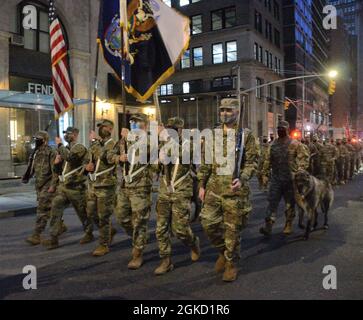 Soldiers of the New York Army National Guard's 1st Battalion, 69th Infantry step off for an abbreviated version of the annual St. Patrick's Day Parade accompanied by Irish Wolfhounds, the traditional mascot of the regiment, in New York City on March 17, 2021 en route to St. Patrick's Cathedral. The regiment has led the parade annually since 1851. Although the usual massive parade-- led by the complete battalion-- was not held due to the pandemic, 50 Soldiers joined the Ancient Order of Hibernians in conducting a smaller version of what is normally the largest St. Patrick's Day Parade in the wo Stock Photo