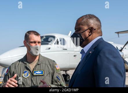 Secretary of Defense Lloyd J. Austin III, right, speaks to Col. Andrew J. Campbell, 374th Airlift Wing commander, during his visit to Yokota Air Base, Japan, March 17, 2021. Austin met with U.S. Forces, Japan leadership during his first overseas trip and discussed the strong working relationship shared between the U.S. and Japan. Stock Photo