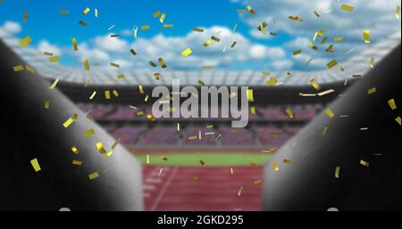 Image of gold confetti falling over empty sports stadium Stock Photo