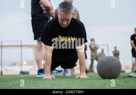 U.S. Army Col. John Herrman, commander of Area Support Group Kuwait, performs the hand release push up for the Army Combat Fitness Test, March 19, 2021, Camp Arifjan, Kuwait. The Hand Release Push-up is an upper body endurance test that represents repetitive and sustained pushing used in combat tasks. Stock Photo
