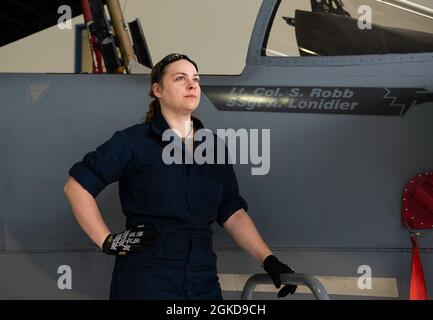 Oregon Air National Guard Staff Sgt. Aimee Lonidier is a Crew Chief assigned to the 142nd Wing, Portland Air National Guard Base, Ore., pauses for a photo with her F-15 Eagle, March 18, 2021. Stock Photo