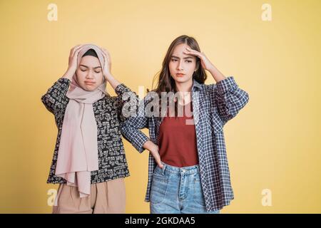 two women with confused expressions while having problems Stock Photo
