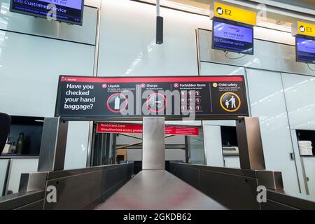 Warning sign showing prohibited banned hand luggage items at check-in belt / passenger check in at Terminal 5 / T5 Heathrow LHR airport. UK (127) Stock Photo