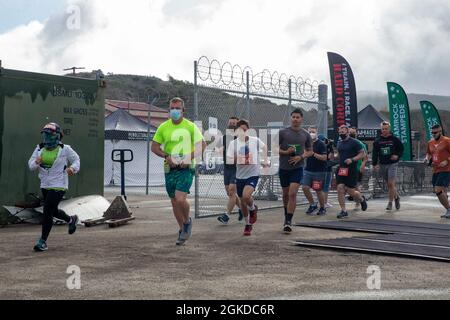 U.S. Marines and family members take off from the starting line of the 2021 Shamrock Stampede Fun Run at Marine Corps Air Station Camp Pendleton, California, March 20, 2021. Marines with Headquarters and Headquarters Squadron, MCAS Camp Pendleton, worked together with Marine Corps Community Services Camp Pendleton in hosting the annual fun run for active duty military members and their families aboard Camp Pendleton, while taking extra precautions to mitigate the spread of disease. The runners had an option of participating in a 10- or 5-kilometer run in celebration of St. Patrick’s Day. The p Stock Photo