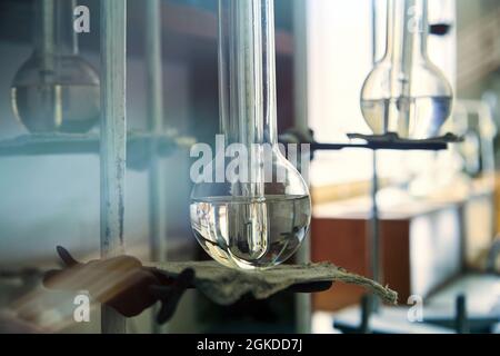 Vintage equipment of chemical laboratory. Antique lab glass flasks. Chemical cabinet. Stock Photo