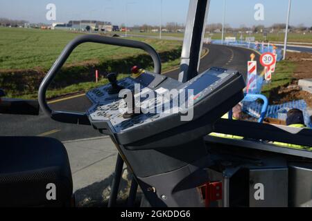 Close view of main control station used to pilot asphalt laying machine during construction of a traffic circle on Chièvres Air Base, Belgium, Mar. 19, 2021. Stock Photo