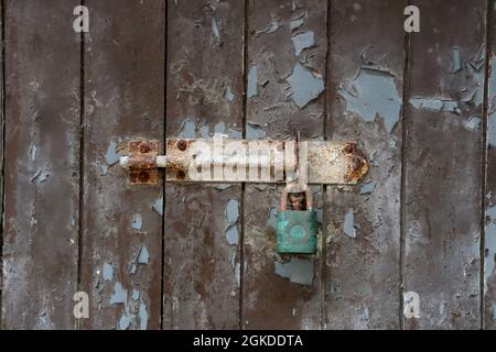 Rusting door bolt on an old disused doorway Stock Photo