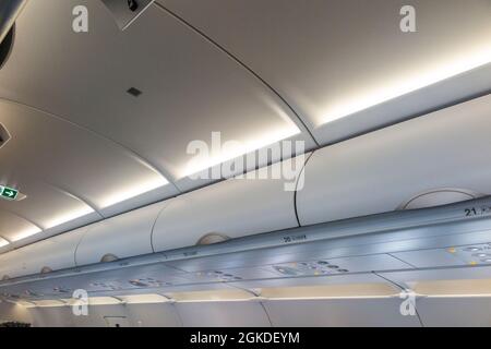 Overhead passenger locker / lockers / compartment / compartments for stowing passengers bags cabin luggage on an Airbus A321 neo plane / airplane. (127) Stock Photo