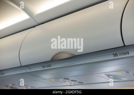 Overhead passenger locker / lockers / compartment / compartments for stowing passengers bags cabin luggage on an Airbus A321 neo plane / airplane. (127) Stock Photo