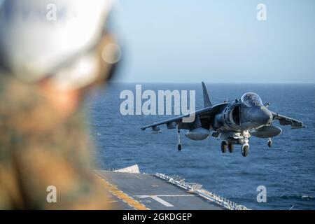 PACIFIC OCEAN (March 21, 2021) An AV-8B Harrier lands on the flight deck of Wasp-class amphibious assault ship USS Essex (LHD 2) during routine flight operations. U.S. Navy and Marine Corps integration training provides the Essex Amphibious Ready Group/11th MEU its first opportunity to plan, brief, and execute multiple mission packages. Essex is underway conducting routine operations in U.S. Third Fleet. Stock Photo