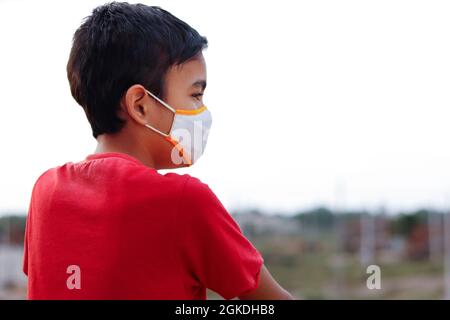 Little Indian cute boy wearing mask during corona virus and flu outbreak. Mask for corona virus prevention. Stock Photo