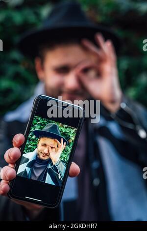 Fashionable young man in a jacket and sunglasses on the street Stock Photo