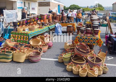 Stalls selling various objects from around the world at Totnes market, South Hams, Devon Stock Photo
