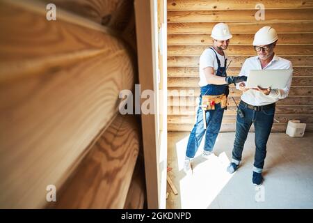 Male worker reaching with hand to type on laptop Stock Photo