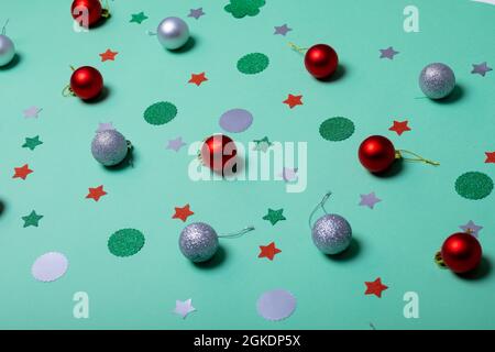 Composition of christmas decorations with baubles and stars on green background Stock Photo