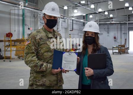 Col. Gavin Gardner, commander of Joint Munitions Command, recognized a variety of Crane Army employees during his visit to the activity, including presenting Lauren Shipman, civil engineer, with a commander’s challenge coin and a commendation letter for her work on the new shipping and receiving facility, slated to open in the summer of 2021. Shipman, Greg Edwards, supervisory supply management specialist, and Matt McGowen, depot operations director, showed Gardner around the facility, which includes in-house inspection bays to streamline the process of moving received munitions to proper stor Stock Photo